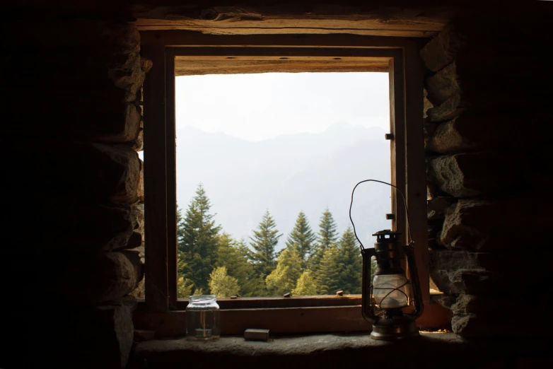 an open window showing mountains seen from inside