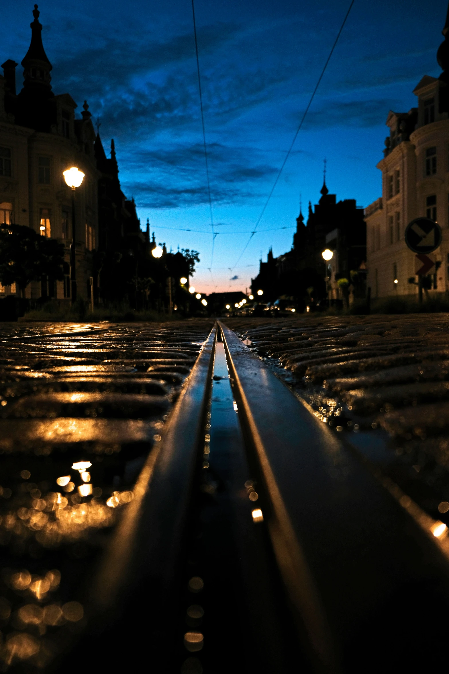 dark picture of street with rain on the ground