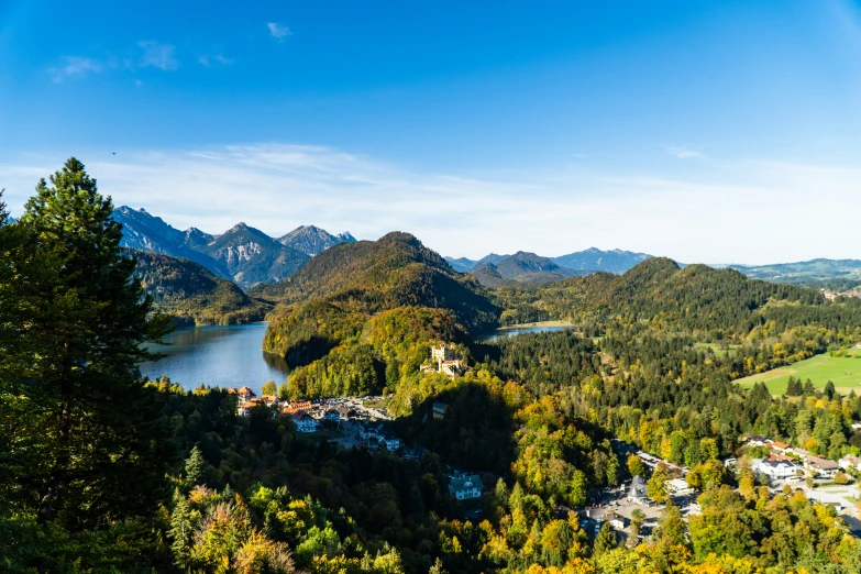 a scenic overlook of trees, mountains and the lake