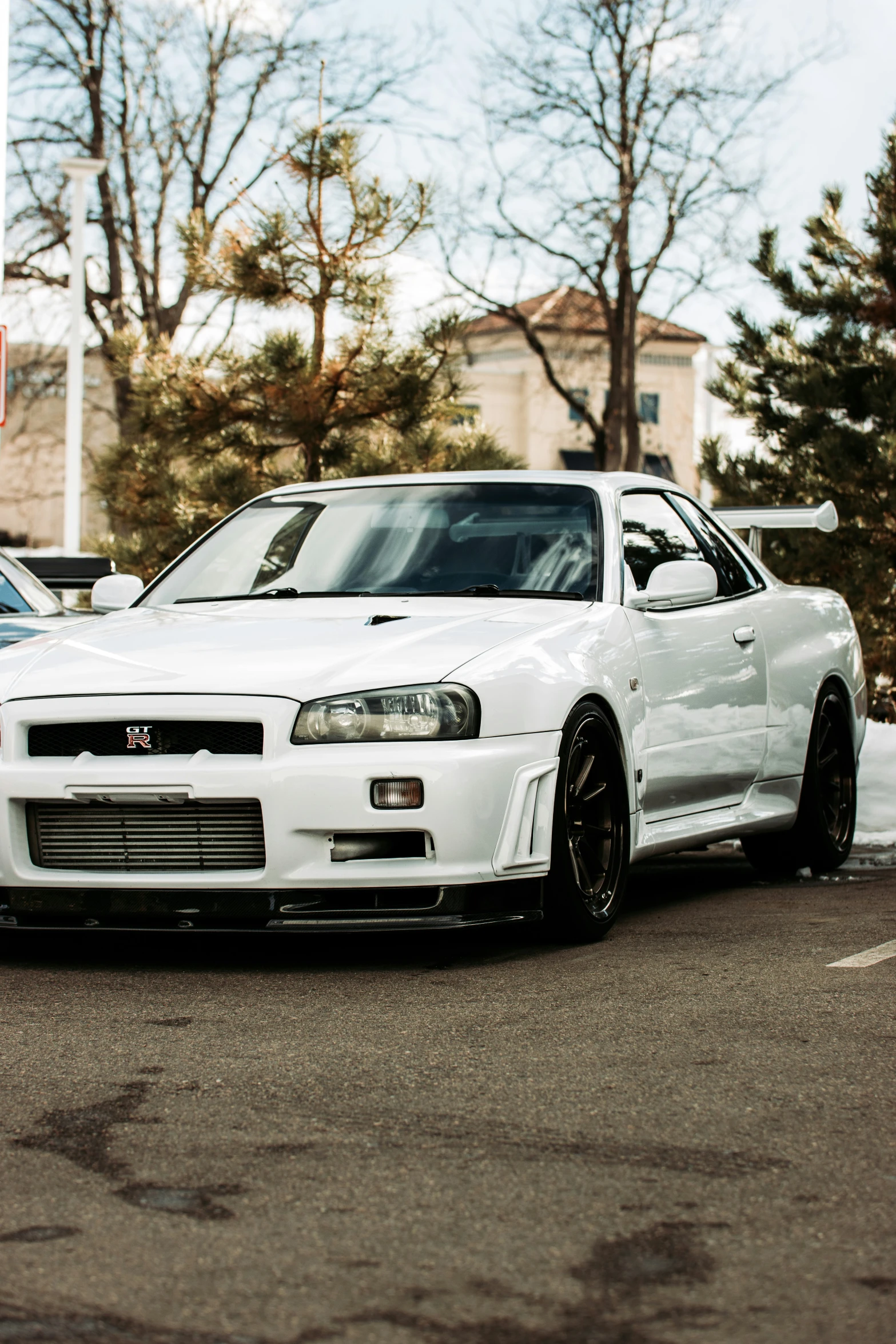 a white sports car parked at a parking meter