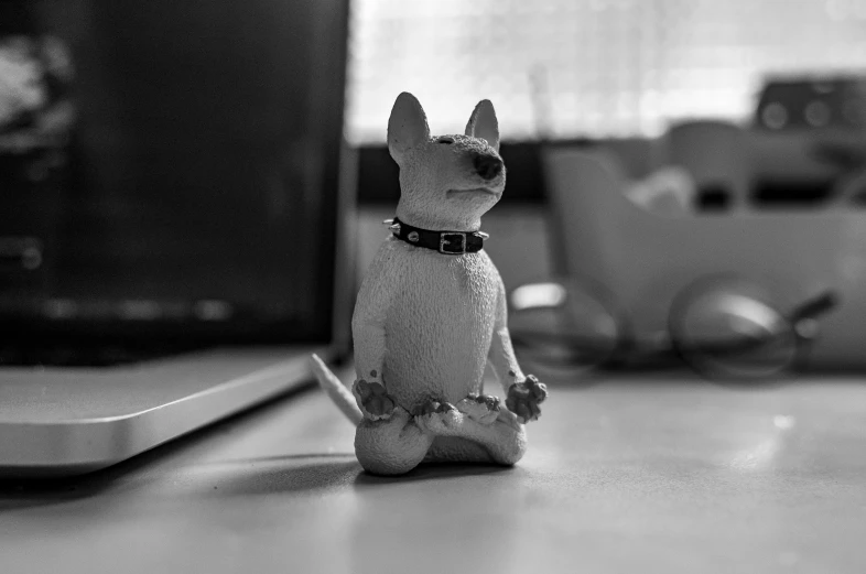 black and white pograph of dog figurine on desk