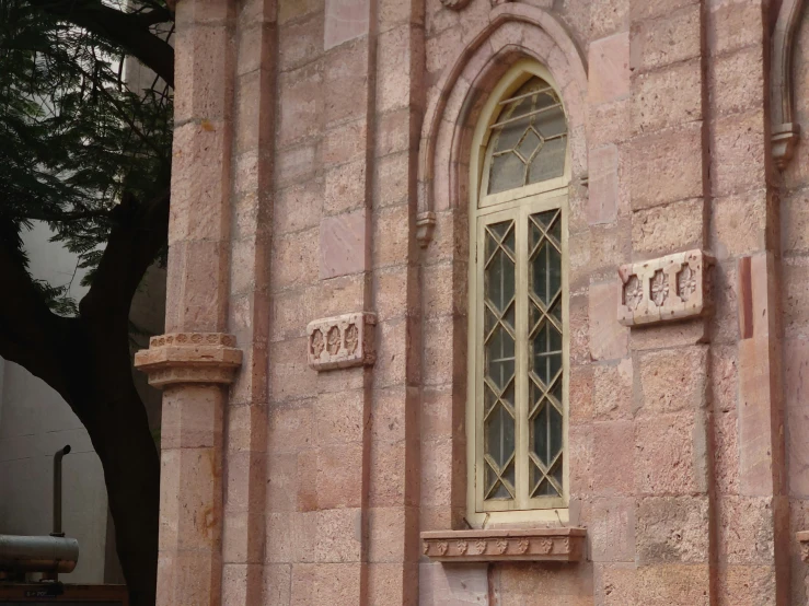 the window of a very nice red stone building