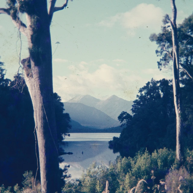 an old po shows a lake and mountain range