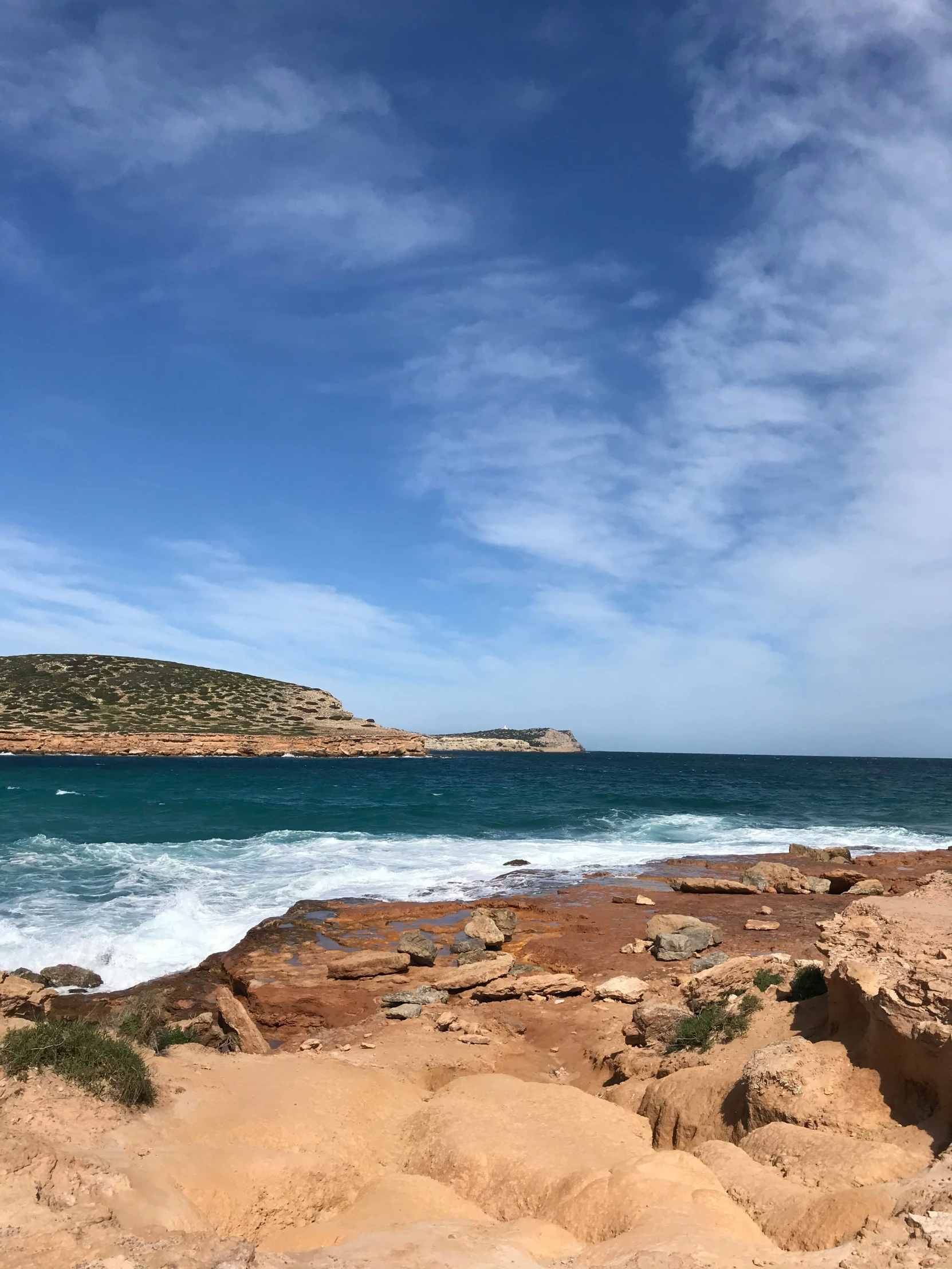 view of the ocean with rocks and waves