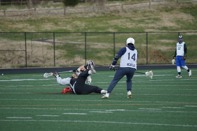 two lacrosse players fight for the ball in a game