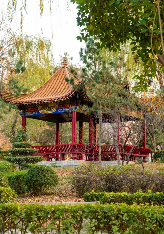 a small building surrounded by trees in a park