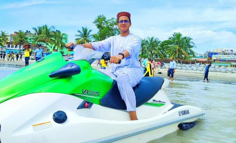 a man wearing white sits on an electric jet ski