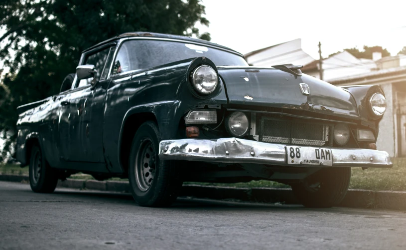 a black classic truck with its license plate is parked