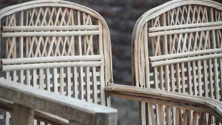 a closeup s of two chairs made of bamboo and white color