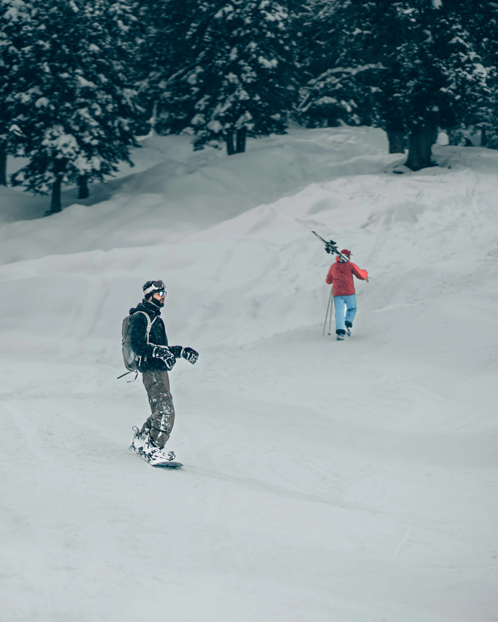 two people walking in the snow with skiis on