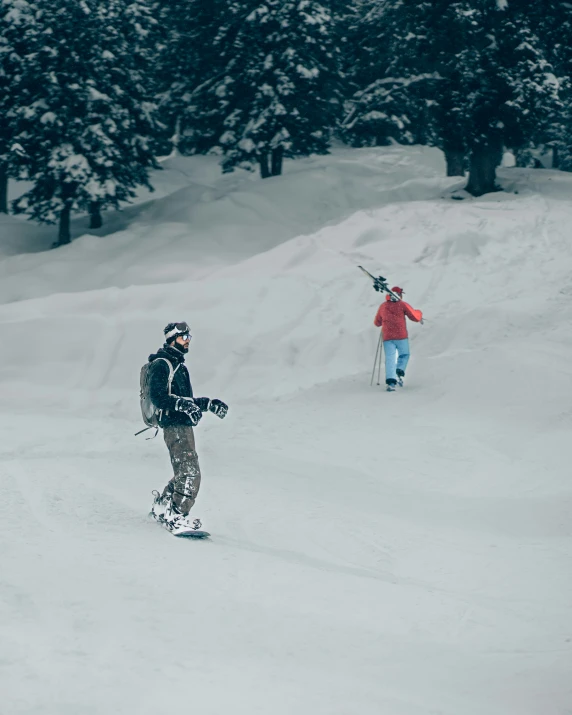 two people walking in the snow with skiis on