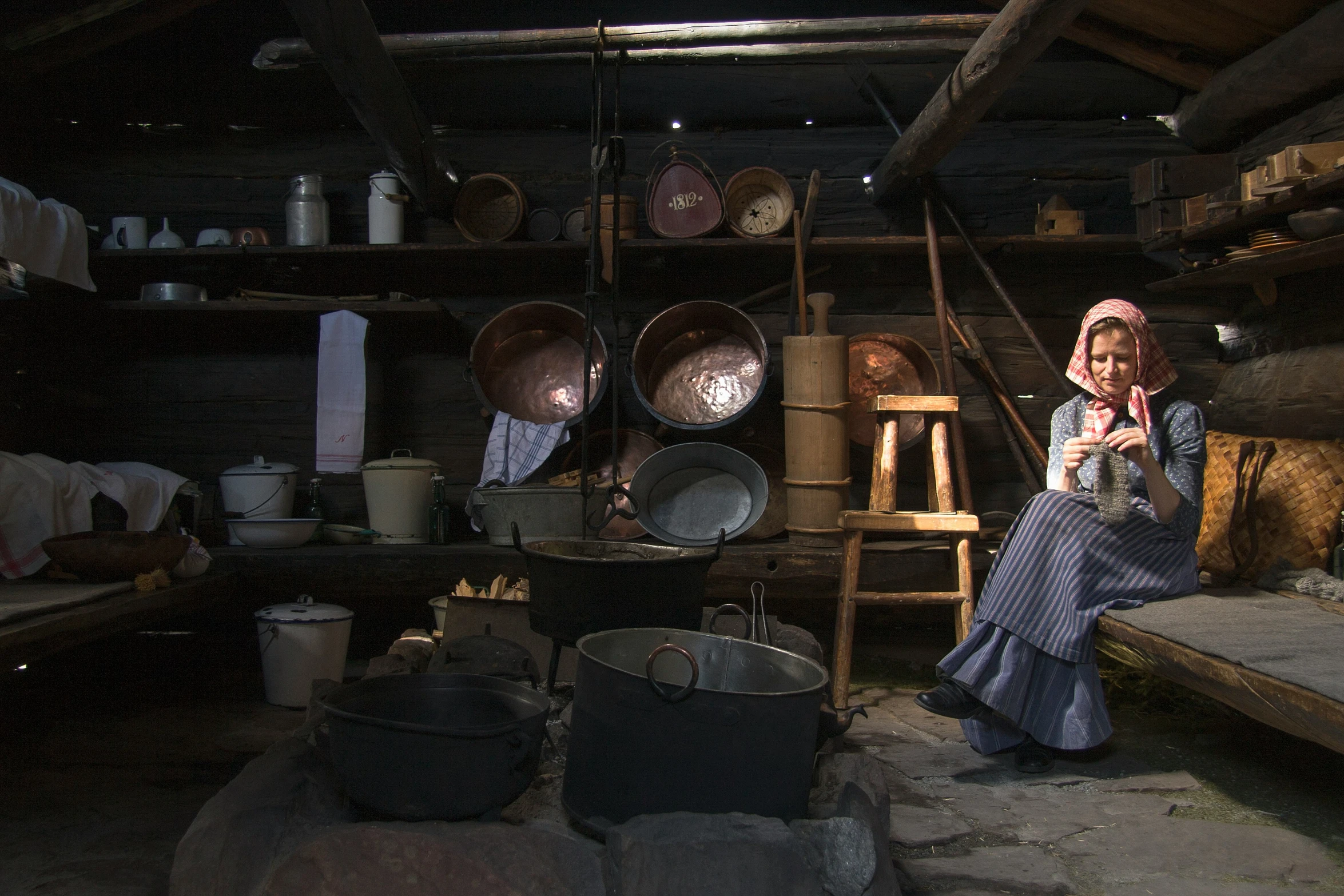 a woman is sitting down by many pots