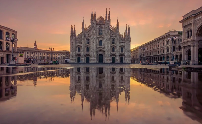 an elegant building with towers stands above a large body of water