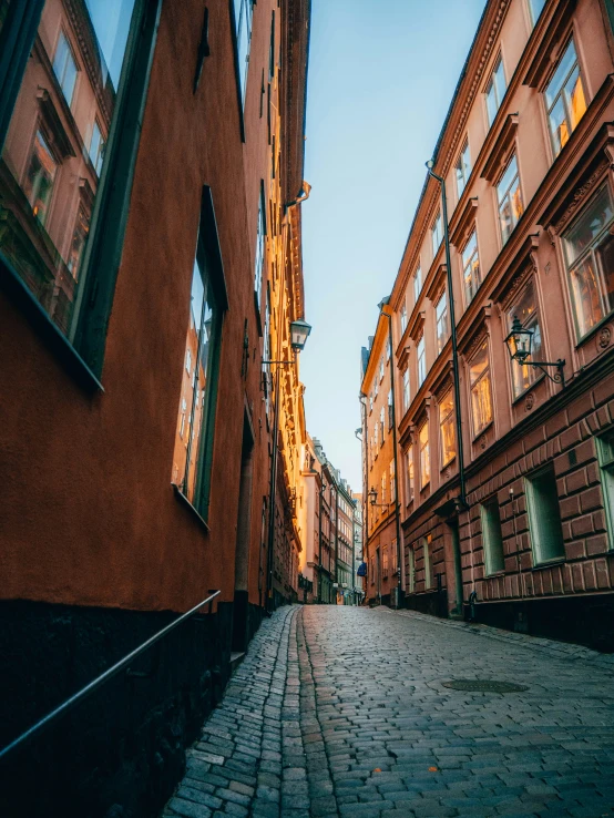 a narrow street with old brick buildings on both sides