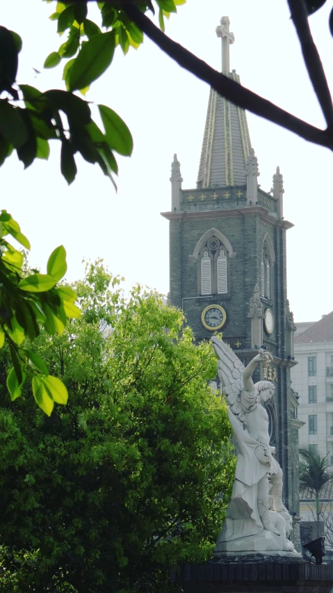 a large church with a tower and some trees