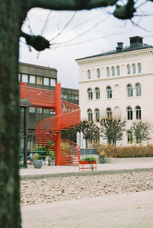 a red staircase is by a white building