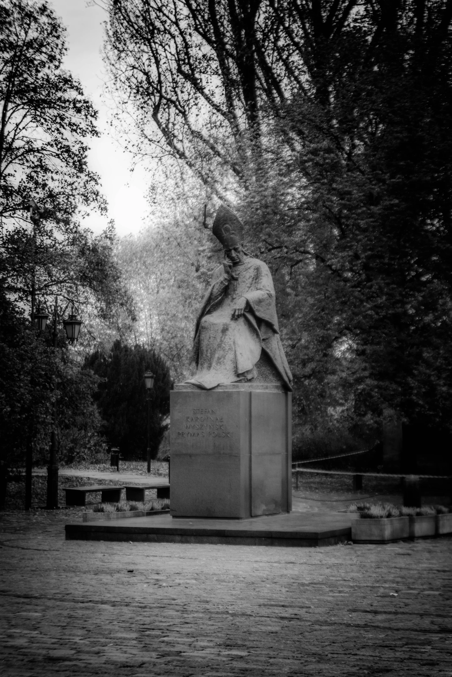 black and white image of a statue in a park