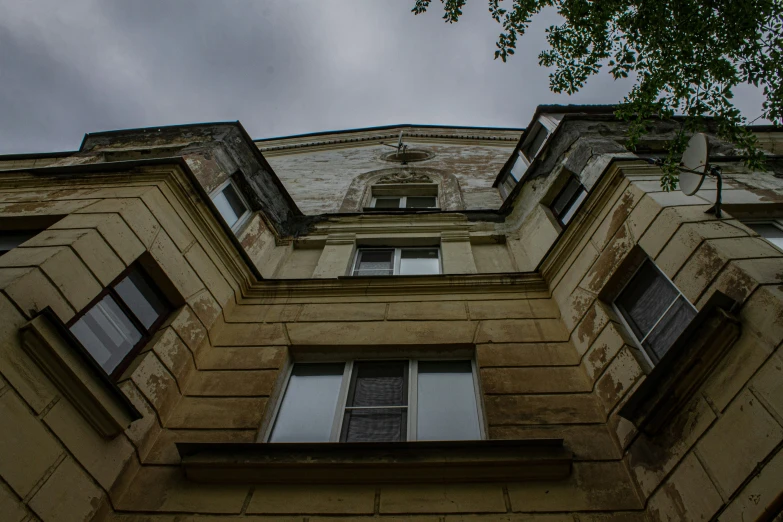 there is a building with three windows and a flag flying high above