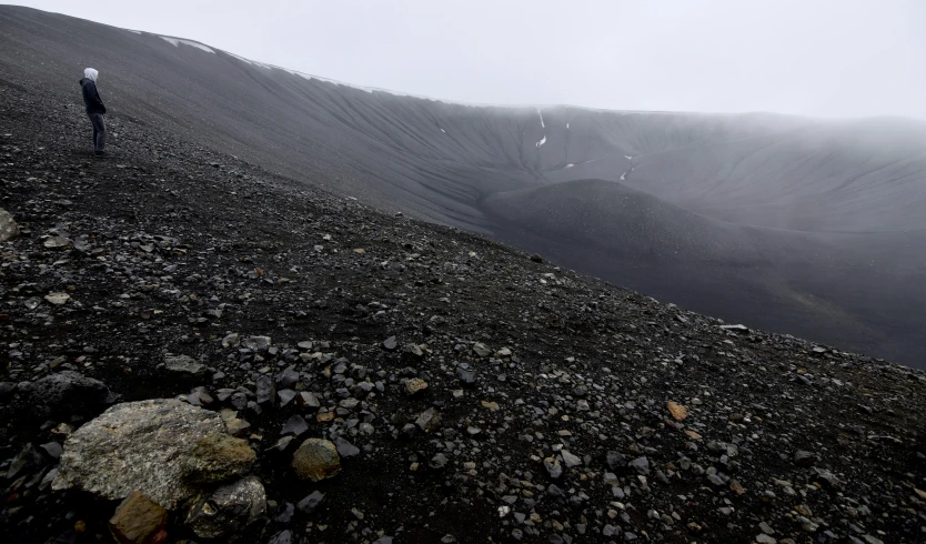 a person standing on top of a rocky hill