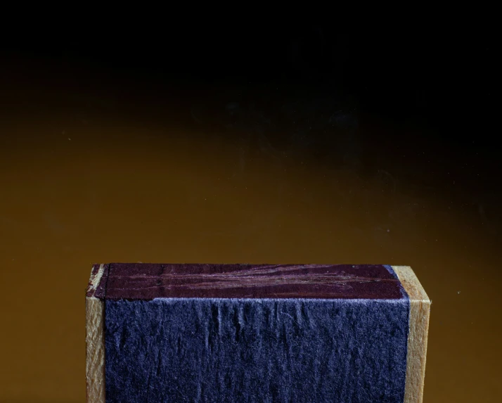 the top of a box with a purple and yellow border