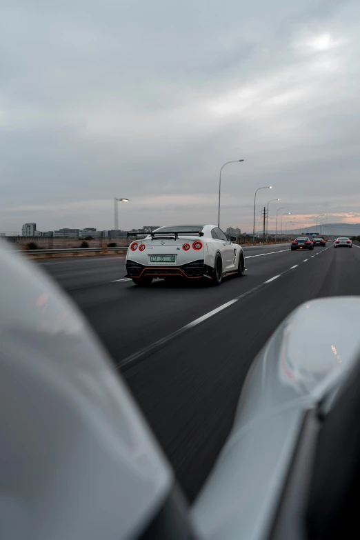 a car moving down the highway with another vehicle passing in view