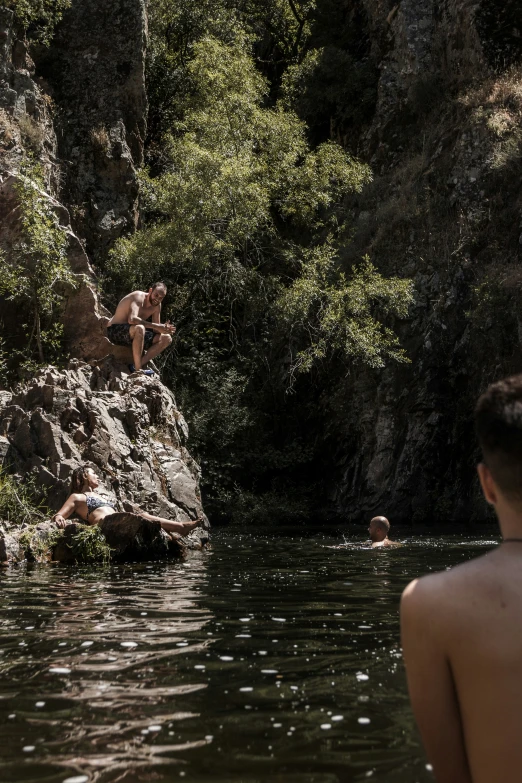 two people floating down a river in a canyon