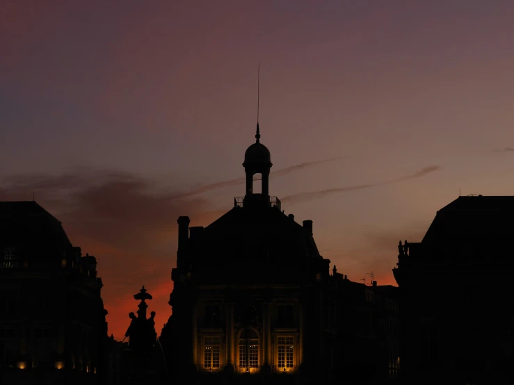 the top of some buildings against a dark sky