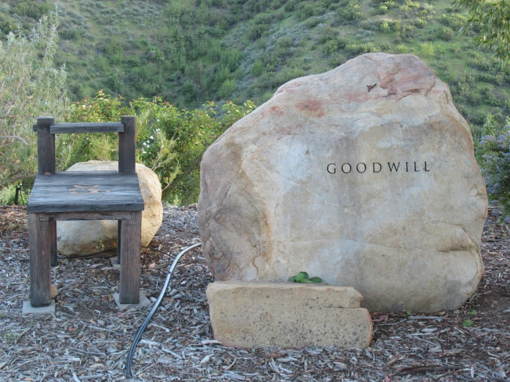 the chair next to a large rock that reads good will