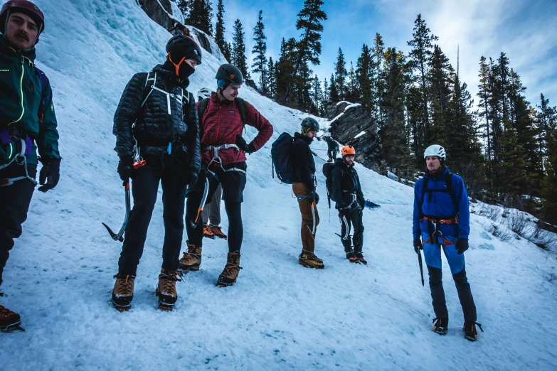 a group of skiers stand on a ski slope