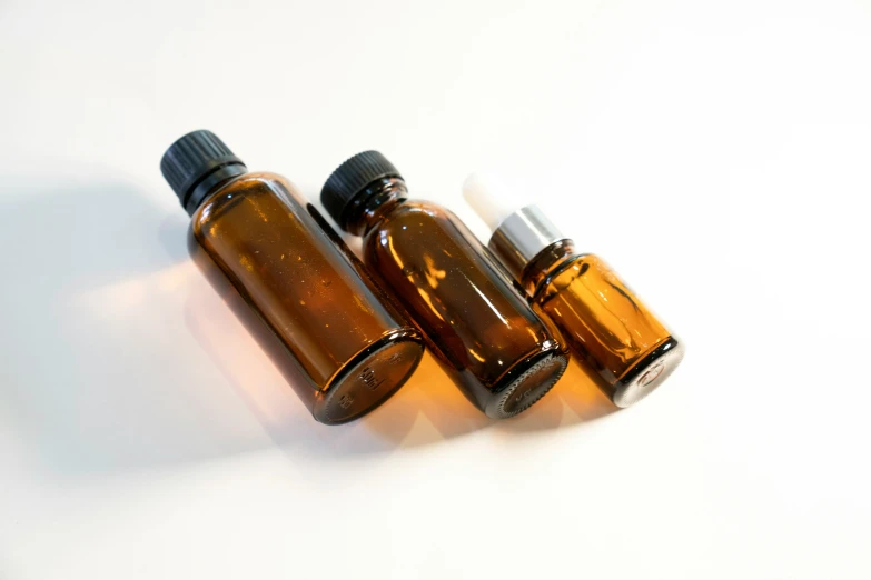 three brown bottles that are filled with liquids