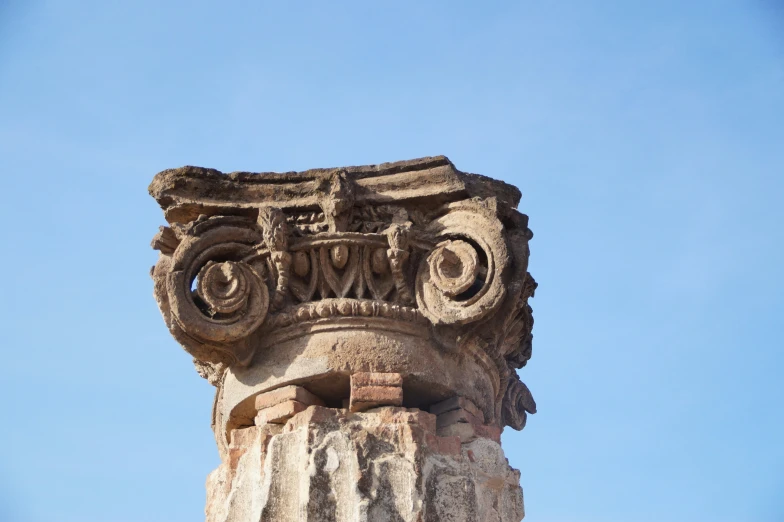 an ancient column with decorative carvings in the city