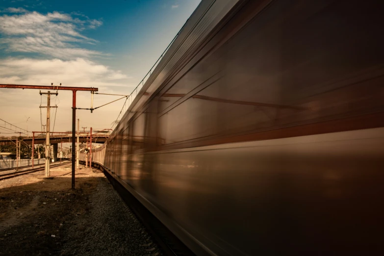 an empty train track in between two power poles