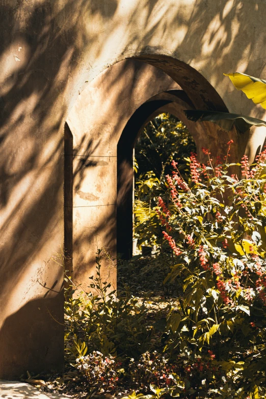 a window is between two wall arches in the shade