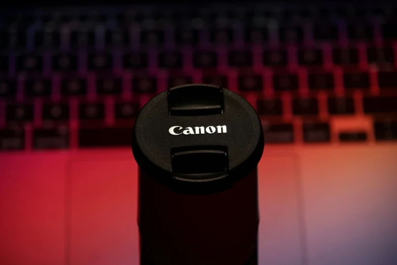close up of camera lens cap and keyboard