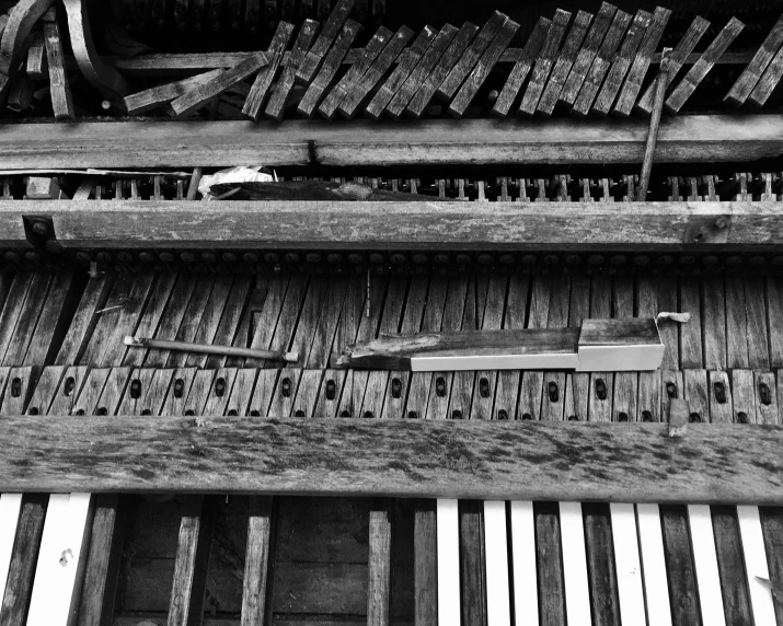 a musical instrument is lying against a set of wooden boards