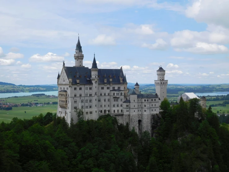 an old castle with towers and a moat on top