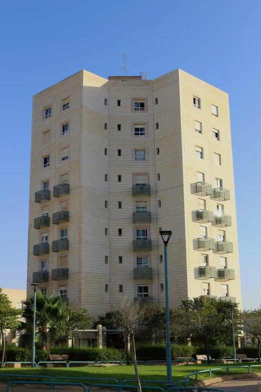 there is a very tall apartment building with balconies