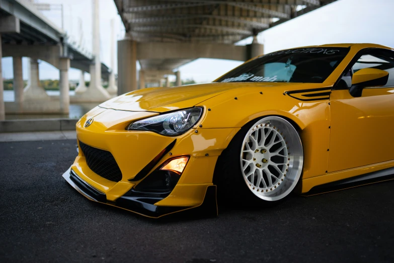 a yellow sports car parked on the side of a street