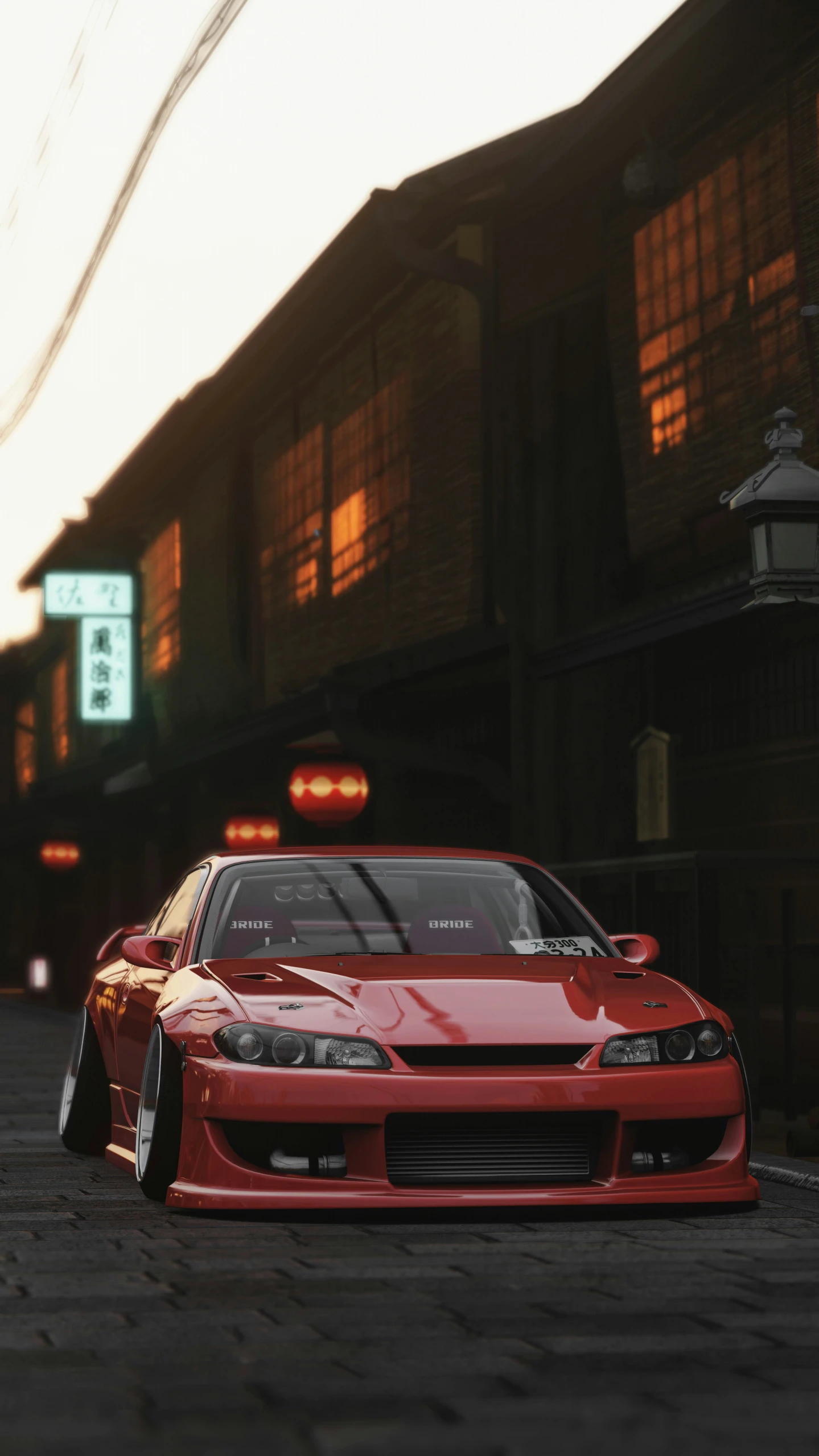 red car parked on cobblestone area in urban setting