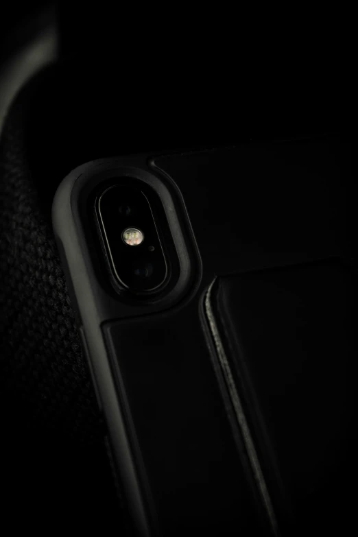 the phone is visible in the dark as it sits on its case