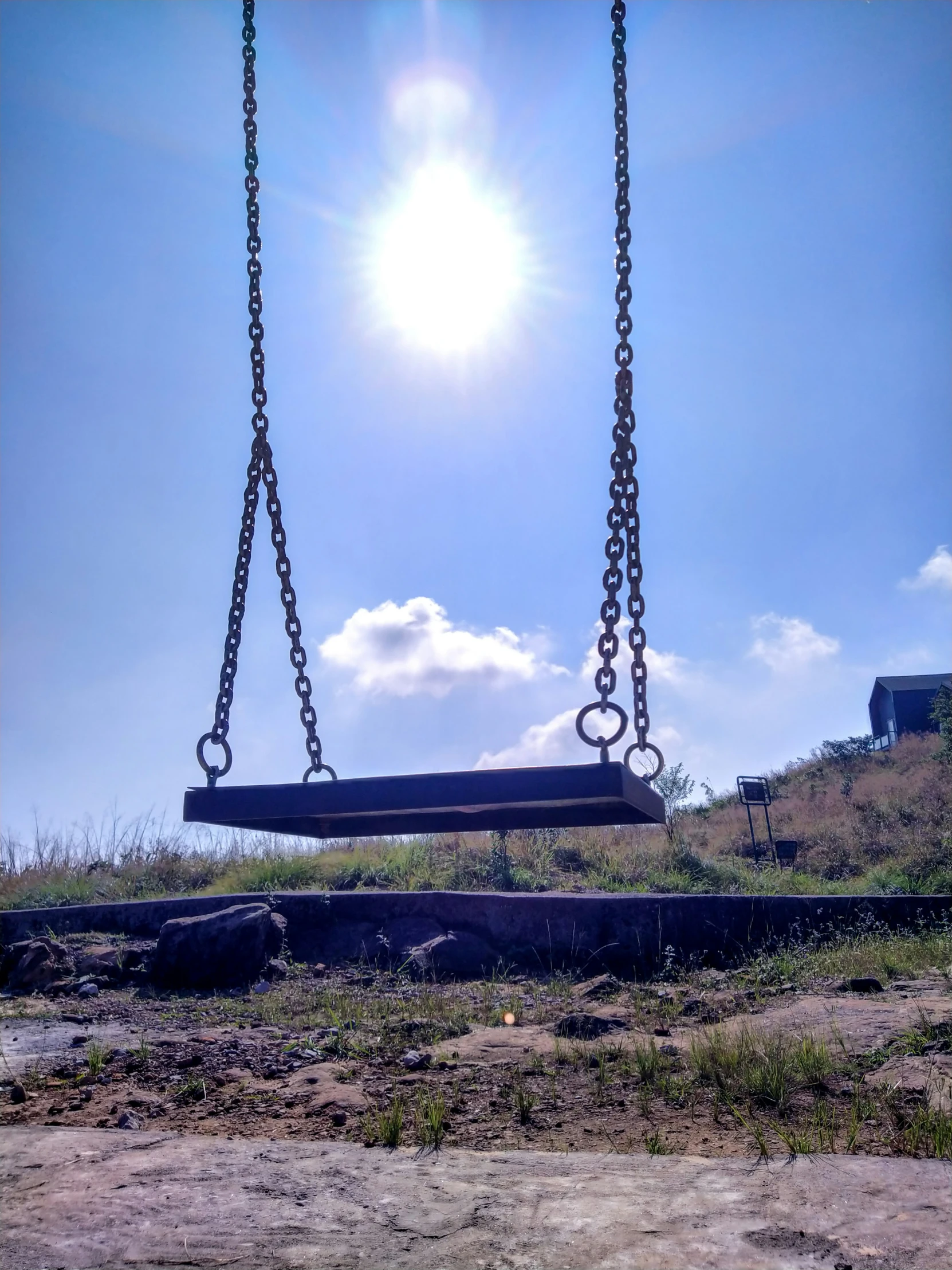 the two swings have swings attached to them