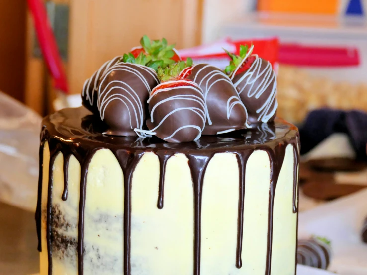 a large chocolate covered cake with a strawberry on top