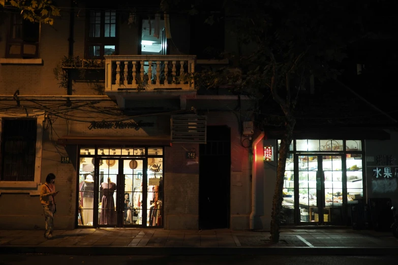 a man standing outside of a door of a store