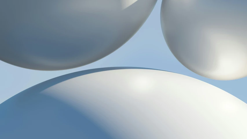 two spheres are shown against a light blue sky