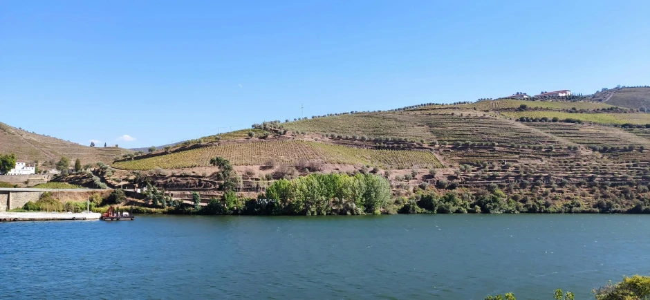 a large body of water with a mountain in the background