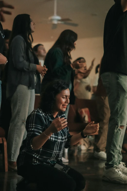 a person that is sitting on the ground with other people