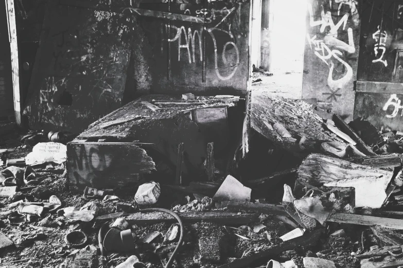 black and white pograph of abandoned building with graffiti on the wall