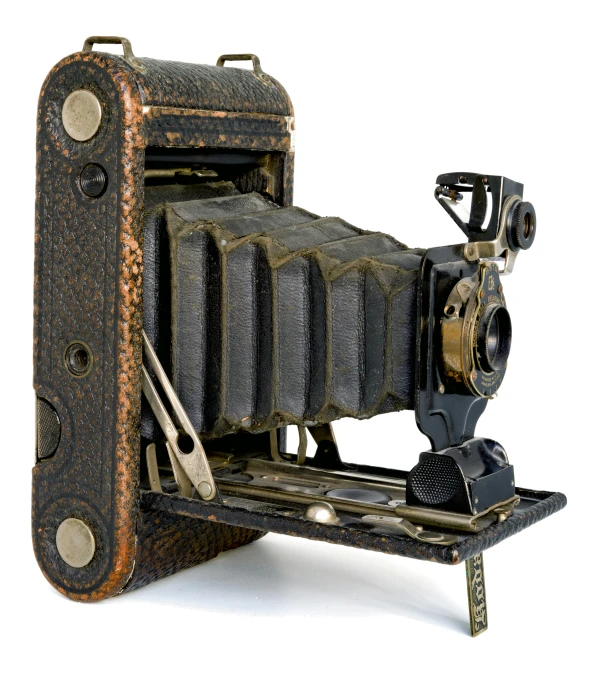 an old vintage camera sitting on top of a desk