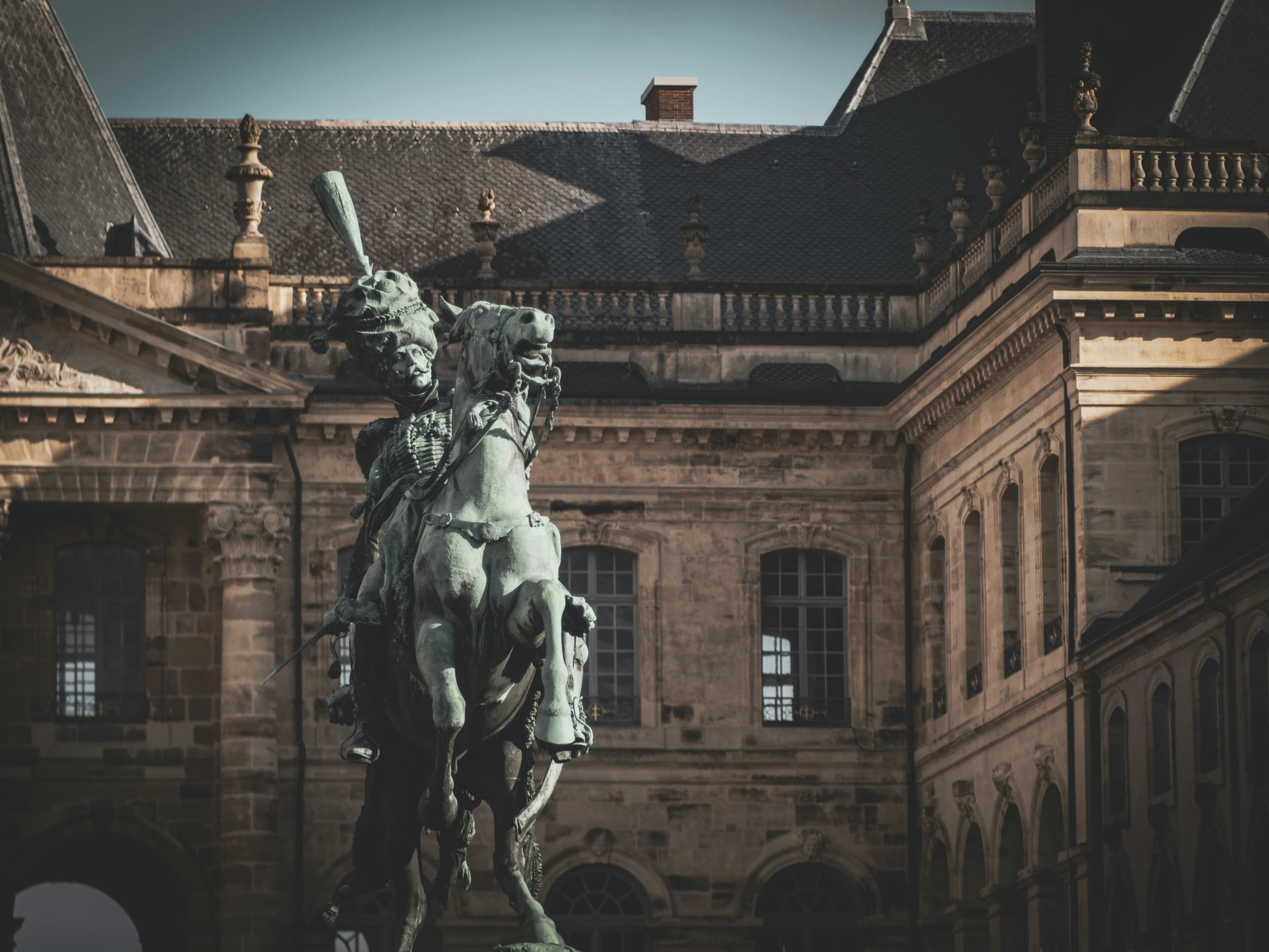 a large statue sits outside a building