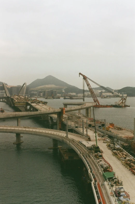 a bridge being built in a harbor with some cranes on top